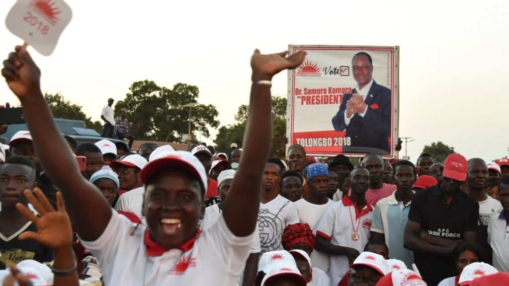 Supporters of Sierra Leone's All People's Congress (APC) presidential candidate Samura Kamara hold a campaign poster during a rally on March 3, 2018, in Kambia. Photo Credit: AFP PHOTO / ISSOUF SANOGOISSOUF SANOGO/AFP/Getty Images