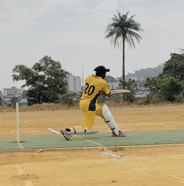 Alice batting the ball aiming to score runs.